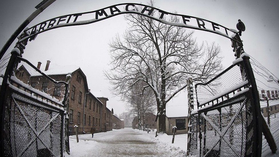 a photo of the sign above gates of nazi death camp