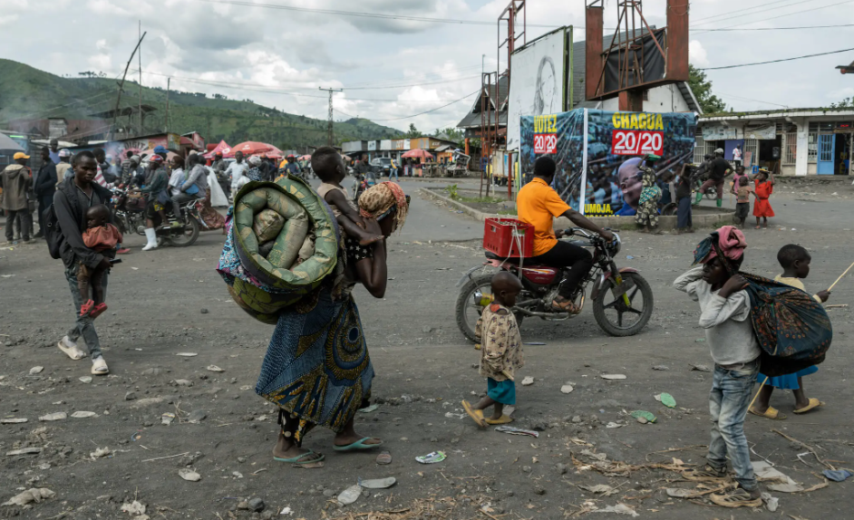 People fleeing fighting this month passed an election poster for Congo’s president, Felix Tshisekedi, in Saké. Parts of eastern Congo are so unstable that voting has been canceled there.